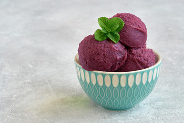 Homemade mulberry, blackberry or blueberry ice cream , sorbet in bowl with mint leaves. Closeup	