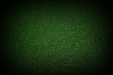 green grass texture background with dark shadow border present football field with the dark and spotlight