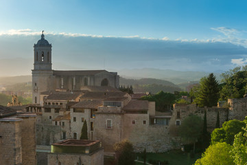 Cityscape, panoramic view of Girona, Catalonia, Spain. The Girona Cathedral. View from the city wall in afternoon sunlight.