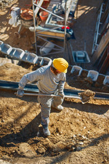 Construction worker on a heavy site doing hard work.