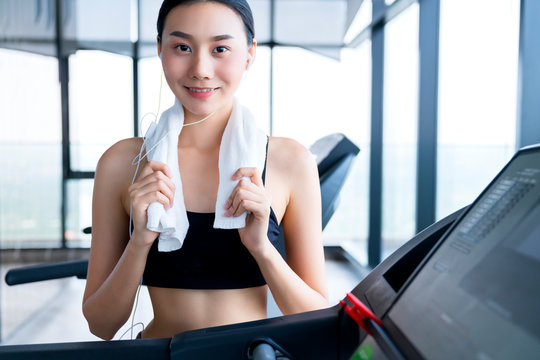 asian healthy aport woman relaxing in gym after workout smile amd look to camera