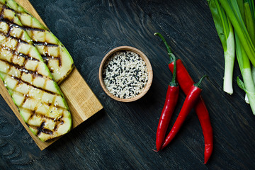 Sesame seeds in a wooden bowl. Roasted sesame seeds. Raw, whole, unprocessed. Natural light. Selective focus. Dark wooden background. © Юлия Ромашко