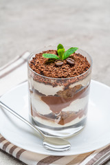 Classic tiramisu dessert in a glass on concrete background