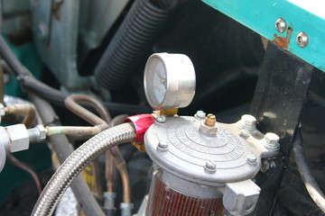 manometer on the fuel filter under the hood of an old car