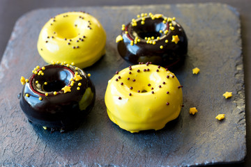 donuts in a glaze mix on a graphite stand