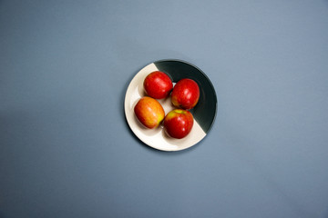 four apples on a plate