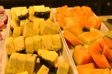 Plate with sliced fruits on servered buffet table