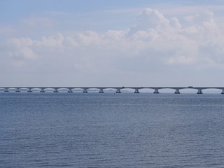 Obraz premium long bridge in the rivers Rhine, Maas delta in the Netherlands, called Zeelandbrug, near the small town Colijnsplaat on the island Beveland at the estuary Oosterschelde