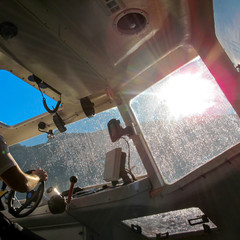 Inside lifeboat when it is floating in the sea. View from inside the cabin control rescue boat with...