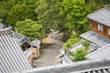 Overhead view of empty stone walkway through traditional Japanese wooden houses