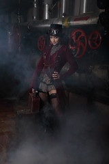 Young beautiful steampunk woman with suitcase