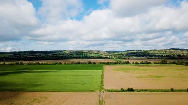 Aerial landscape ascending shot of cloudy bright and shady view of agricultural areas hills summer zala county hungary europe