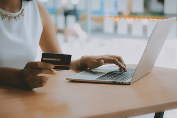 woman using computer & credit card for online shopping