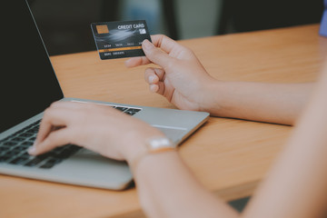 woman using computer & credit card for online shopping