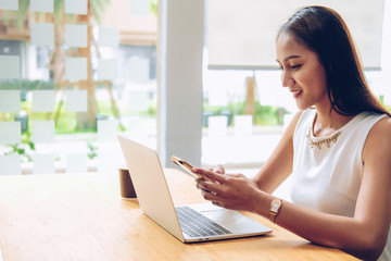 asian woman using mobile smartphone in cafe coffee shop