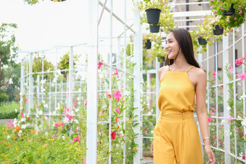 woman relaxing enjoying summer nature in flower garden