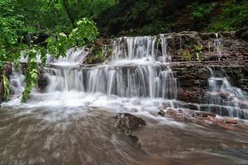 Obraz premium Mountain river waterfall landscape. Cascade of Dzhurynskyi waterfall.