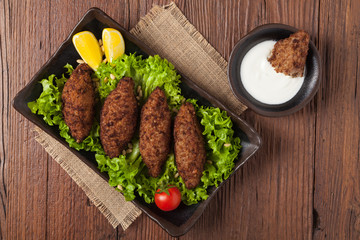 Traditional arabic kibbeh with lamb and pine nuts.