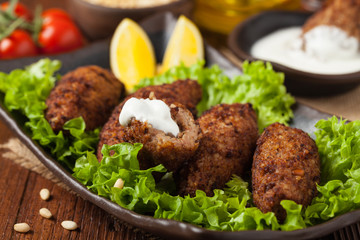 Traditional arabic kibbeh with lamb and pine nuts.