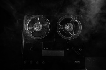 Special agent intelligence officer listens to conversations and records on a reel to reel tape...