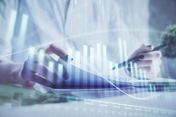 Financial chart drawn over hands taking notes background. Concept of research. Multi exposure