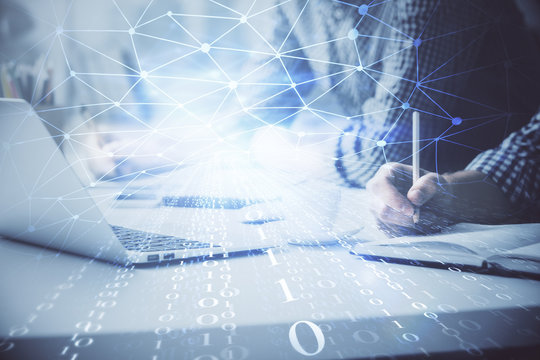 Businessman with computer background with technology theme hologram. Concept of hightech. Multi exposure.