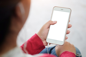 Cropped shot view of man hands holding smart phone with blank copy space screen for your text message or information content, female reading text message on cell telephone during in urban setting. 