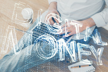 Crypto currency theme hologram with businessman working on computer on background. Concept of blockchain. Double exposure.