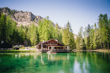 Fototapeta na wymiar The lodge over the turquoise waters of Lago Ghedina, an alpine lake in Cortina D'Ampezzo, Dolomites, Italy
