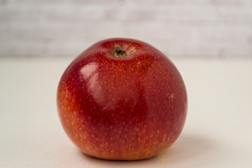 Fresh red apple on plain white background. There is a place for text. Healthy food concept.