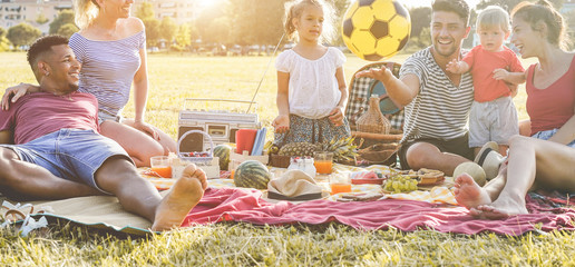 Happy families making picnic in city park - Young parents having fun with their children in summer...