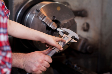 good father took his little son to work with metal. Concept of relationship, child at work turner