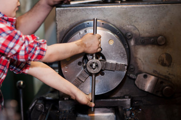 good father took his little son to work with metal. Concept of relationship, child at work turner