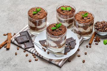 Classic tiramisu dessert in a glass on concrete background