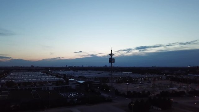 Drone flight over the parking lot towards the tower of the Munich trade fair complex in Riem, Bavaria, Germany