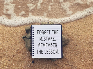 Motivational and inspirational wording - Forget The Mistake, Remember The Lesson written on a...