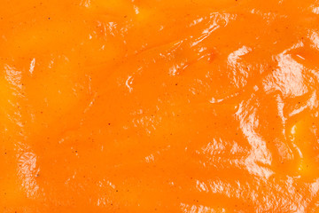 Orange sauce splashes as background.