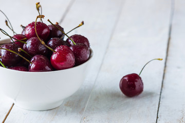 cherries in wooden bowl on the table  copy space 