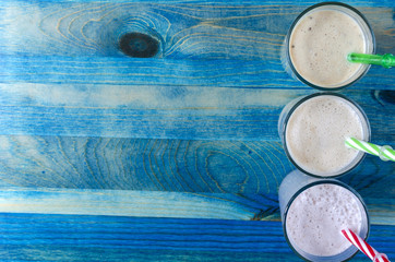 fruit milkshakes in a transparent dish on a blue background
