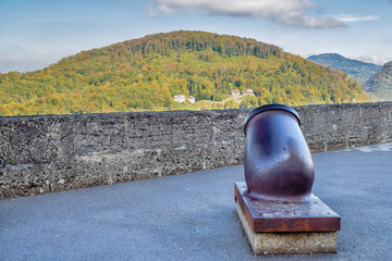 Old metal cannon with nature background in fortress in Salzburg Austria in sunny day at autumn