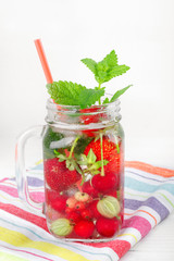 Two glasses with drink of fresh ripe berries on beautiful towel