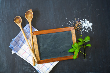 Cooking ingredients and utensils, free copy space on the blank kitchen black board