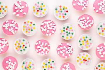 Colorful cupcakes on a white background.