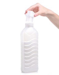 Softener conditioner in white plastic bottle in hand isolated on white background. Bottle with liquid laundry detergent, cleaning agent, bleach or fabric softener.