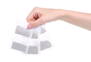 herbal tea bags in hand on white background isolation