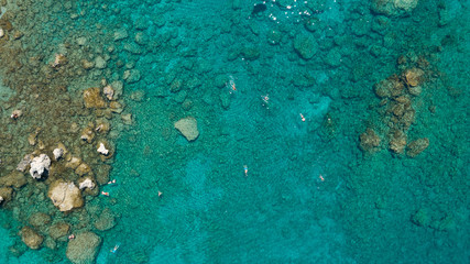 Fototapeta na wymiar Aerial view of sea with tourists swimming in beautiful clear turqoise water.