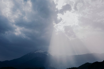 The outlines of mountains and hills through the morning atmospheric fog in blue color. A picturesque place for trekking. Fantasy postcard, copyspace.