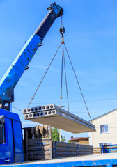 A crane raised a concrete slab at a construction site at home