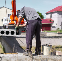 Installing concrete slabs at a construction site at home