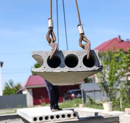 Installing concrete slabs at a construction site at home